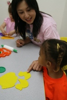 Miss Tracy teaching a 12-36mos old girl animals in Mandarin through Play-doh